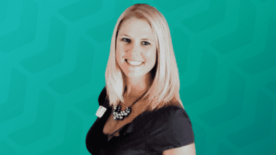 Headshot of Kelli Garcia in front of green chevron background